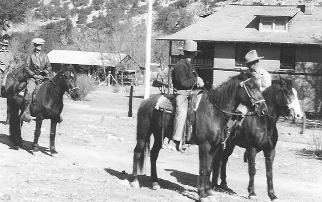 Riders on horseback in front of the Faraway Ranch house in 1919