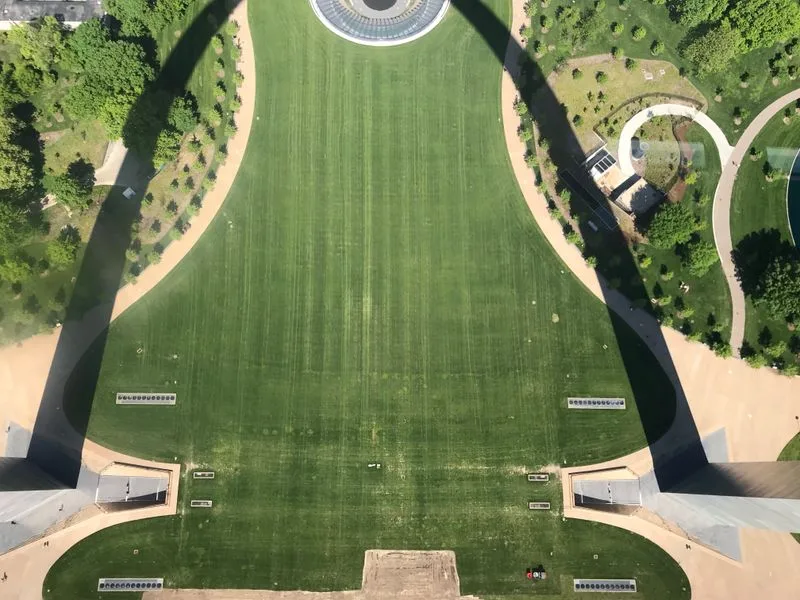 Aerial view looking straight down through the Gateway Arch's legs onto the museum grounds below