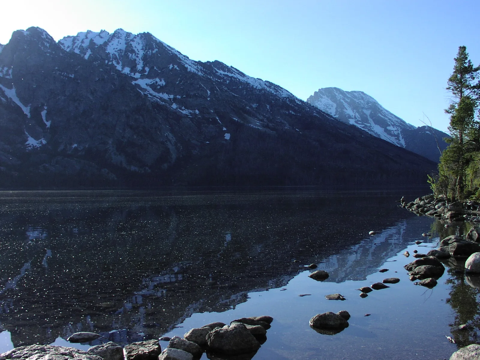 Calm water reflecting the Teton Range, similar to the still ponds at Schwabacher Landing